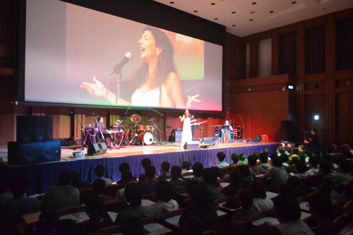 Nitza Melas singing enthusiastically at a concert commemorating the release of the KCG Group's 50th anniversary CD album 