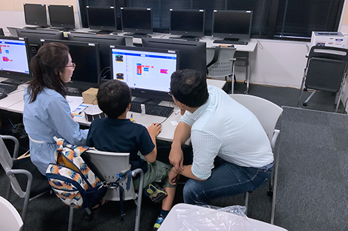 Parents and children trying their hands at programming